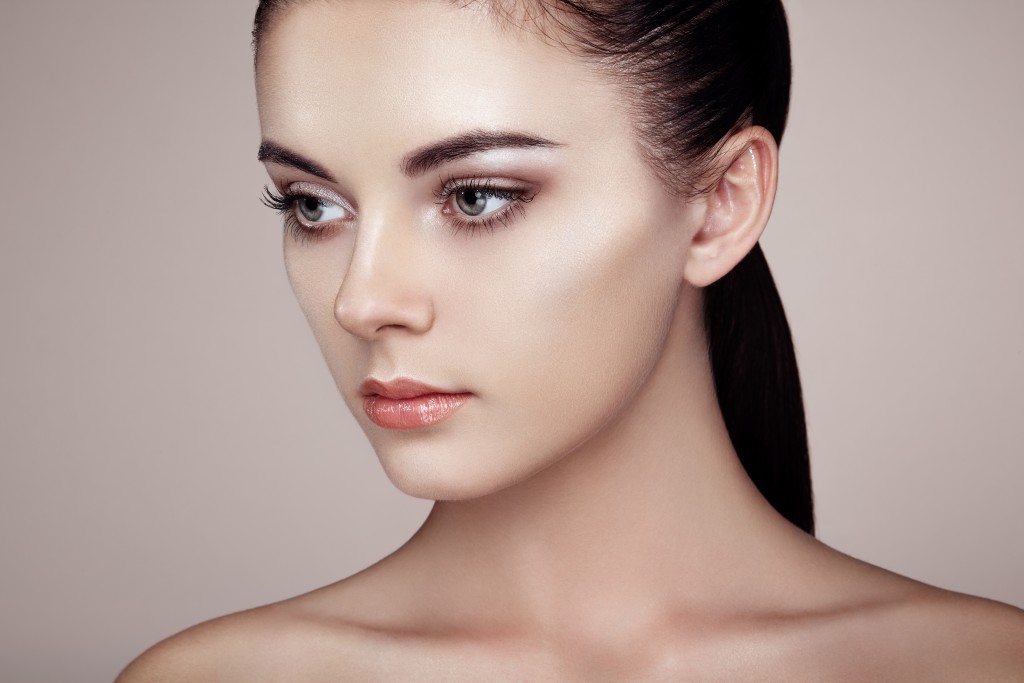 Beautiful woman face. Perfect makeup. Beauty fashion. Eyelashes. Cosmetic Eyeshadow. Highlighting